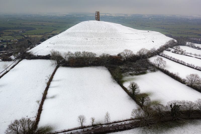 Snow settles on Glastonbury Tor. PA