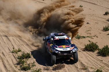 Mini's Spanish driver Carlos Sainz and co-driver Lucas Cruz compete during Stage 1 of the 2021 Dakar Rally between Jeddah and Bisha in Saudi Arabia, on January 3, 2021. during the prologue near the Saudi city of Jeddah, on the eve of the 2021 Dakar Rally, on January 2, 2021 / AFP / FRANCK FIFE