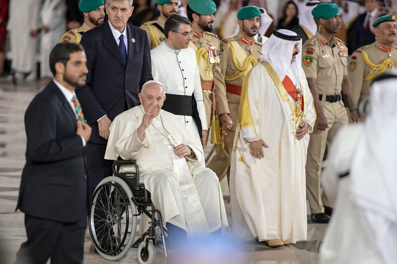 Pope Francis, centre, is escorted by Bahrain's King Hamad as he leaves the Royal Palace in the capital Manama. Khushnum Bhandari / The National