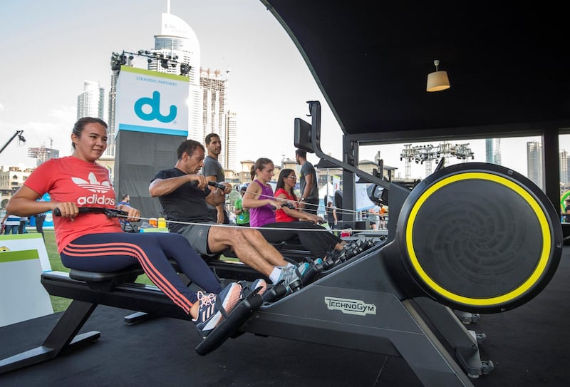 DUBAI, UNITED ARAB EMIRATES - Participants doing rowing exercise at the closing weekend carnival of the second year of the Dubai Fitness Challenge at Burj Park, Dubai.  Leslie Pableo for The National