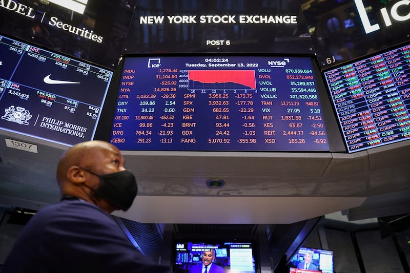A trader stands beneath a screen at the New York Stock Exchange. Oil prices have been volatile due to looming sanctions on Russian crude and concerns about China's economy. Reuters
