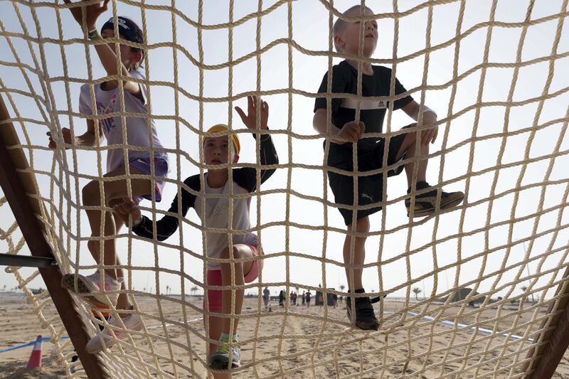 ABU DHABI, UNITED ARAB EMIRATES. 11 OCTOBER 2019. The Tough Mudder sports event held on Hudayriat Island in Abu Dhabi. Kids compete and enjoy the obstacles and challenges on the Mini Mudder course specially designed for children. (Photo: Antonie Robertson/The National) Journalist: None. Section: National.
