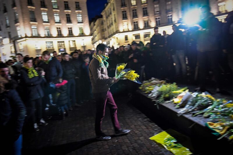 A Nantes supporter adds to the collection of flowers. AFP