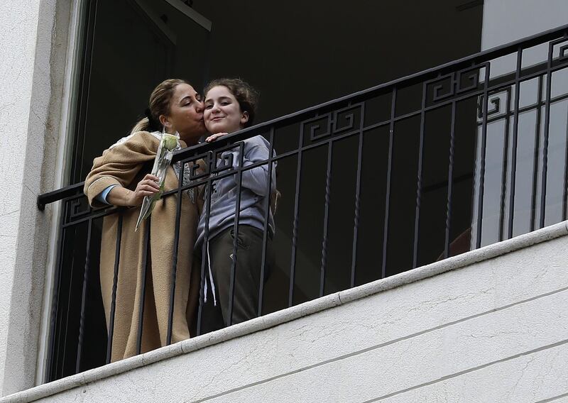 A woman who just received a rose delivered to her via a drone on Mother's day, thanks her daughter with a kiss, in the coastal city of Jounieh, north of the capital Beirut. AFP