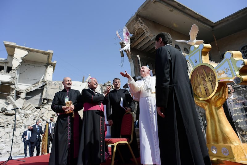 Pope Francis releases a white dove during a prayer for war victims at 'Hosh al-Bieaa', Church Square, in Mosul's Old City. Reuters