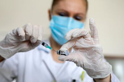 epa08938926 A nurse prepares a dose of Pfizer-BioNTech COVID-19 vaccine during the vaccination at Novi Beograd medical center in Belgrade, Serbia, 15 January 2021. Serbia began its coronavirus disease (COVID-19) vaccination campaign of elderly and medical workers on 24 December 2020.  EPA/MARKO DJOKOVIC