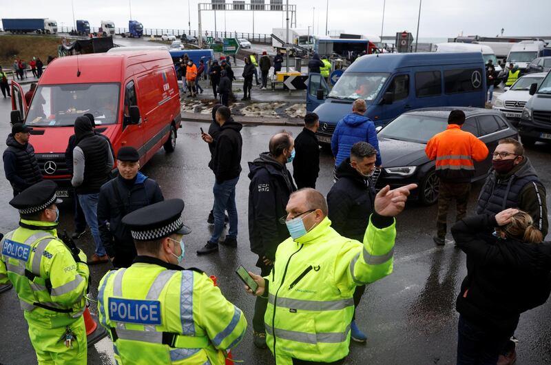 Drivers talk with police officers at the entrance of the Port of Dover, as EU countries impose a travel ban from the UK following the coronavirus disease (COVID-19) outbreak, in Dover, Britain.  REUTERS