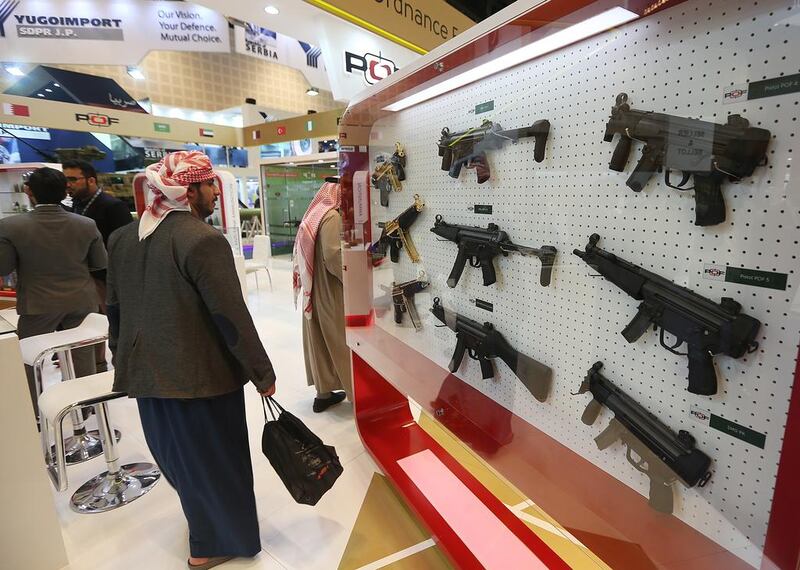 Above, firearms are on display at the Pakistan Ordnance Factories stands. Satish Kumar / The National