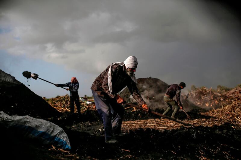 Palestinians work at al-Hattab charcoal production facility, east of Gaza City. Al-Hattab charcoal-making facility is the largest producer in the Gaza Strip. AFP
