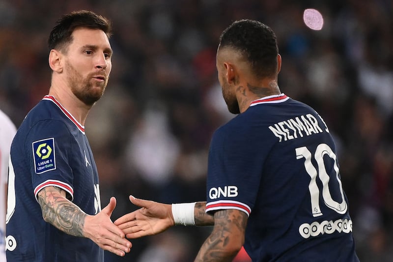 Paris Saint-Germain's Argentinian forward Lionel Messi congratulates Neymar after he scored a penalty against Lyon. AFP