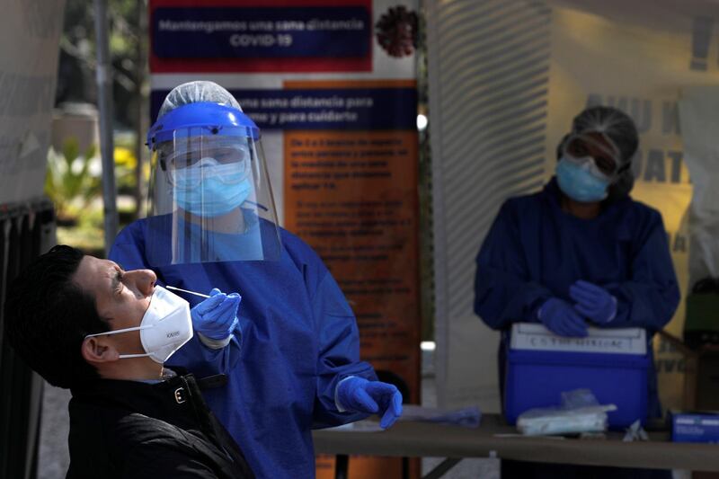 A healthcare worker takes a swab sample from a man to be tested for Covid-19 in Mexico City, Mexico. Reuters