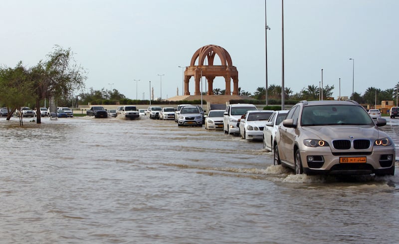 Vehicles make their way along a flooded street in the aftermath of Cyclone Shaheen in Muscat. Photo: AFP