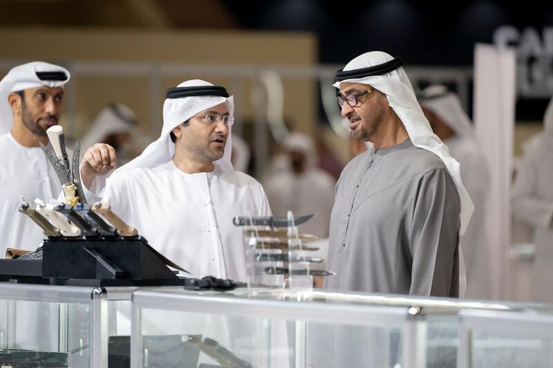 President Sheikh Mohamed speaks with two exhibitors during his tour of Adihex on Monday. Mohamed Al Hammadi / UAE Presidential Court
