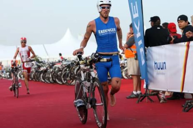 Competitors in 2012's Abu Dhabi International Triathlon transition from the swim portion to the bicycle segment. At 200 kilometres for the long course it is some 23 kilometres more than a standard triathlon and is what sets the Abu Dhabi event apart.