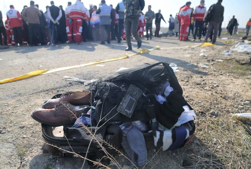 TEHRAN, IRAN - JANUARY 08: Belongings of passengers are brought from the site by search and rescue team members after a Boeing 737 plane belonging to a Ukrainian airline crashed near Imam Khomeini Airport in Iran just after takeoff with 180 passengers on board in Tehran, Iran on January 08, 2020. All 167 passengers and nine crew members on an Ukrainian 737 plane that crashed near Iran's capital Tehran early Wednesday have died, according to a state official. (Photo by Fatemeh Bahrami/Anadolu Agency via Getty Images)