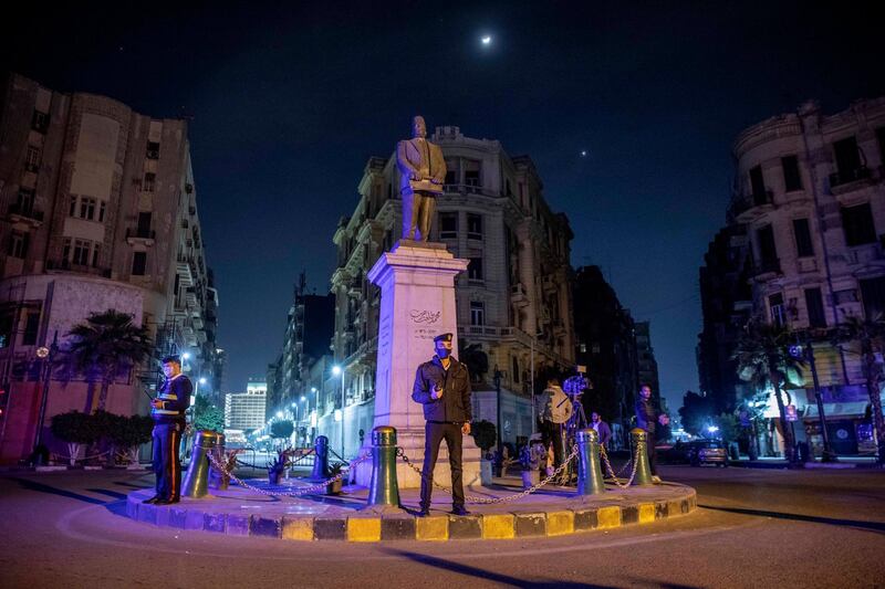 Egyptian security forces cordon off roads during curfew hours as prevention measures due to the coronavirus outbreak, in downtown Cairo, Egypt. AP Photo