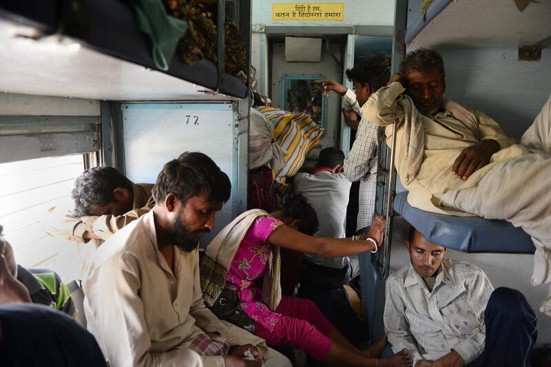 Indian passengers sleep on board the Kalka Mail train