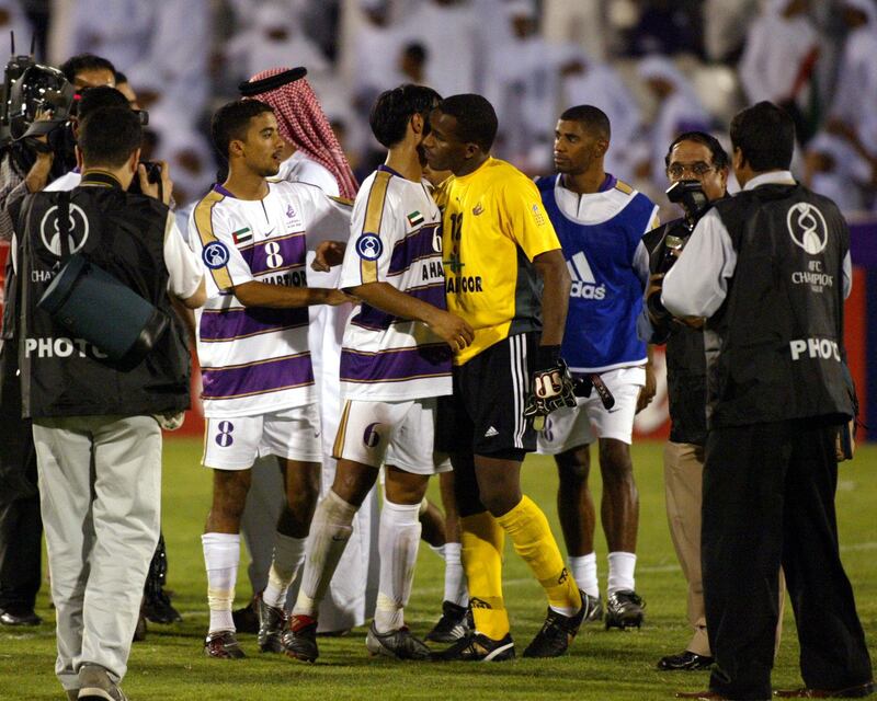 Emirati players Ali Ahmad Ali (L) and Ali Rashed Abdullah (C) congratulate their goal keeper Waleed Salem (R) after the victory against Thai Tero Sasana club during their AFC Champions League final in Al-Ain 03 October 2003. Al Ain beat Sasana 2-0. AFP PHOTO/Rabih MOGHRABI (Photo by RABIH MOGHRABI / AFP)