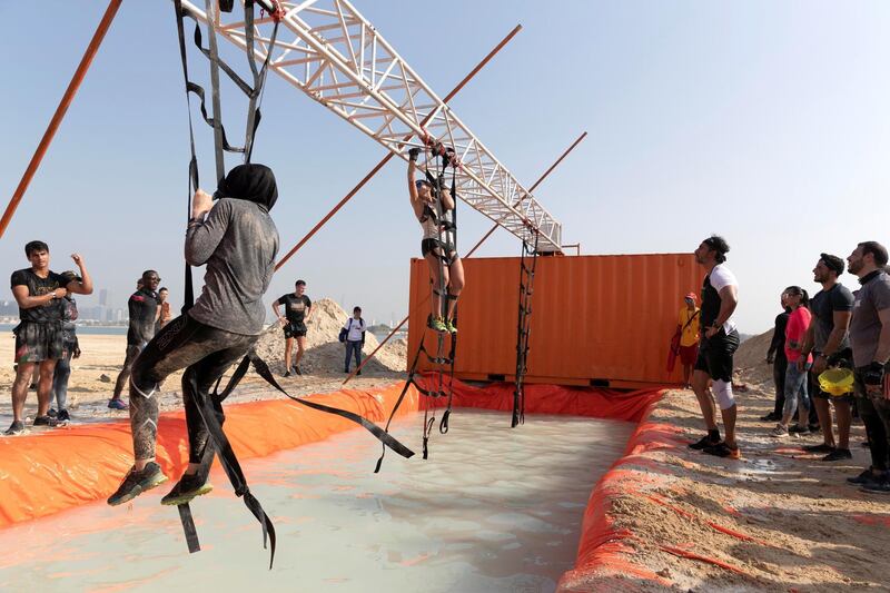 ABU DHABI, UNITED ARAB EMIRATES. 11 OCTOBER 2019. The Tough Mudder sports event held on Hudayriat Island in Abu Dhabi. The main Tough Mudder event challenged dedicated and amateur athletes with a 5km course designed to get participants moving over obstacles and along a dedicated route engineered to build team spirit. (Photo: Antonie Robertson/The National) Journalist: None. Section: National.

