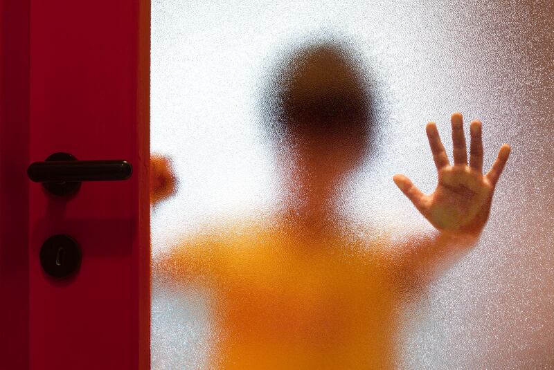 Behind door blurred boy leaning open hand against glass. (Getty Images) *** Local Caption ***  op22ja-child-protection.jpg