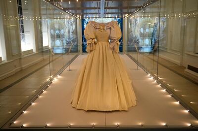 The wedding dress of Britain's Princess Diana is displayed during a media preview for the "Royal Style in the Making" exhibition at Kensington Palace in London, Wednesday, June 2, 2021.  The exhibition, which opens to visitors on Thursday and runs until January 2, 2022, explores the intimate relationship between fashion designer and royal client. (AP Photo/Matt Dunham)
