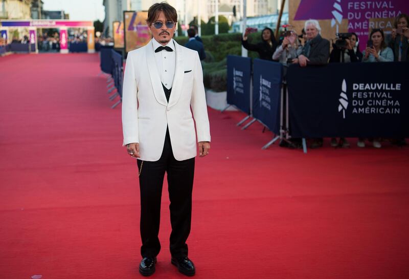 Johnny Depp poses on the red carpet as he arrives to receive an homage award at the 45th Deauville American Film Festival on September 8, 2019. AFP