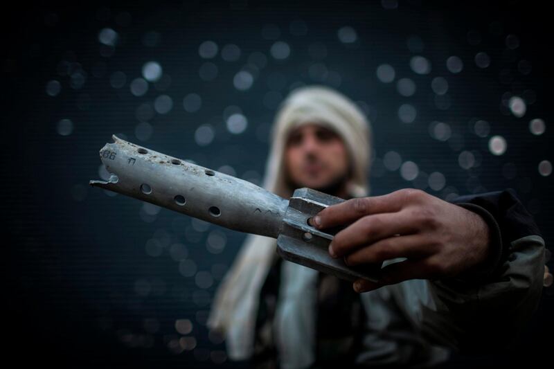 A Free Syrian Army fighter displays a damaged ordinance in Aleppo, Syria, Tuesday, Jan. 15, 2013. Two explosions struck the main university in the northern Syrian city of Aleppo on Tuesday, causing an unknown number of casualties, state media and anti-government activists said. (AP Photo/Andoni Lubaki) *** Local Caption ***  APTOPIX Mideast Syria.JPEG-0419a.jpg