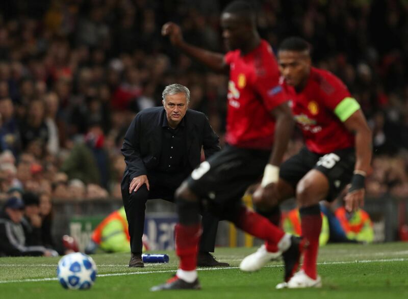 Manchester United manager Jose Mourinho looks on while Manchester United's Eric Bailly and Antonio Valencia challenge for the ball. Reuters