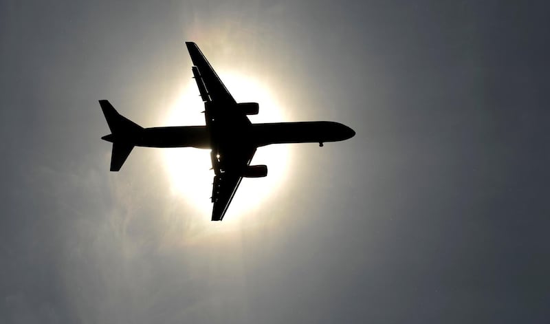 FILE PHOTO: A plane approaching Leeds Bradford airport passes in front of the sun in Leeds May 26, 2013. REUTERS/Philip Brown/File Photo