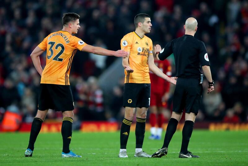 Wolves players Conor Coady (centre) and Leander Dendoncker appeal to referee Anthony Taylor after VAR disallows Pedro Neto's goa. PA