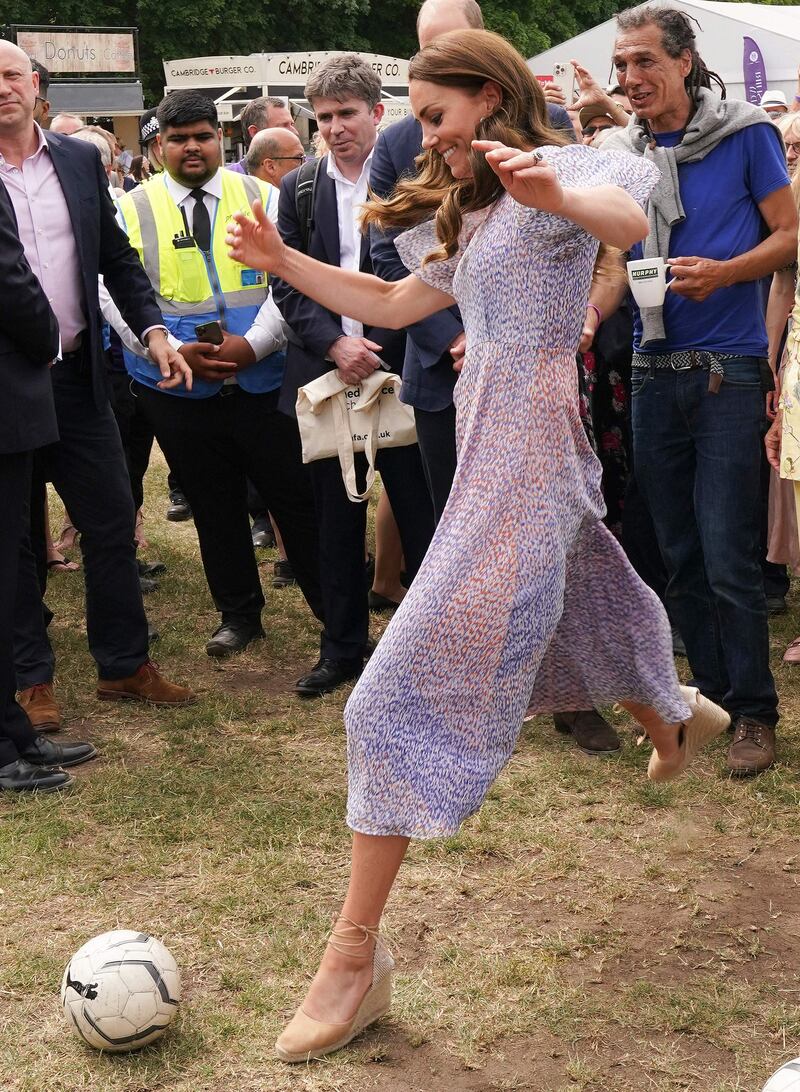 Kate, Duchess of Cambridge shows her football skills during a visit to Cambridgeshire County Day, at Newmarket racecourse, on Thursday. AFP