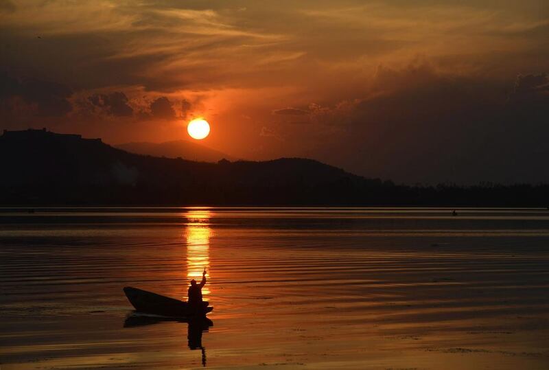 A Kashmiri man paddles his boat on Dal Lake during sunset in Srinagar. Tauseef Mustafa / AFP Photo