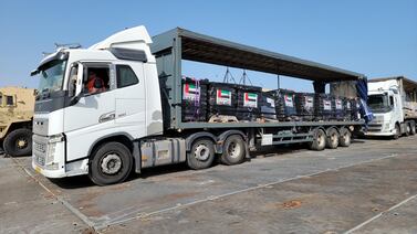 Trucks loaded with humanitarian aid from the UAE and USAID on the new pier on the Gaza coast on May 17, 2024.  EPA