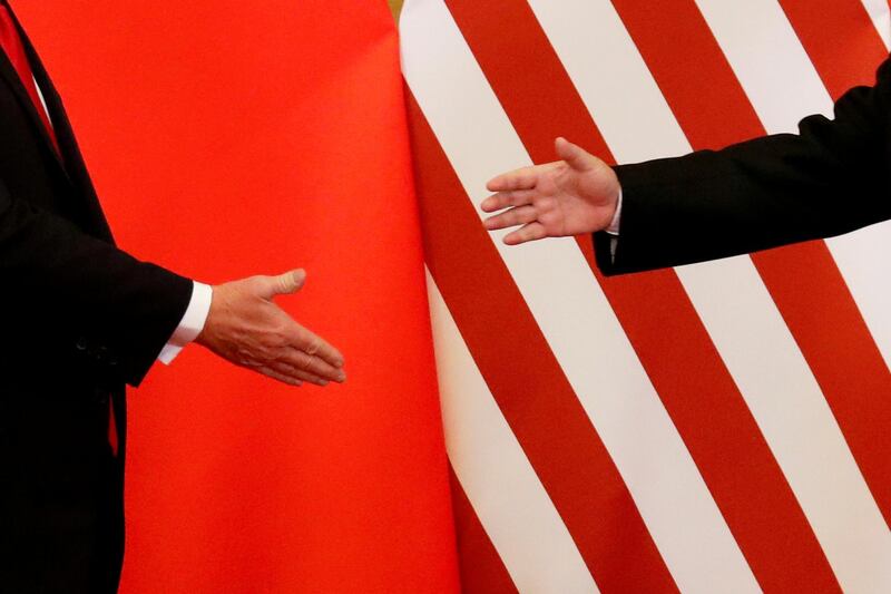 FILE PHOTO: U.S. President Donald Trump and China's President Xi Jinping shake hands after making joint statements at the Great Hall of the People in Beijing, China, November 9, 2017.   REUTERS/Damir Sagolj/File Photo