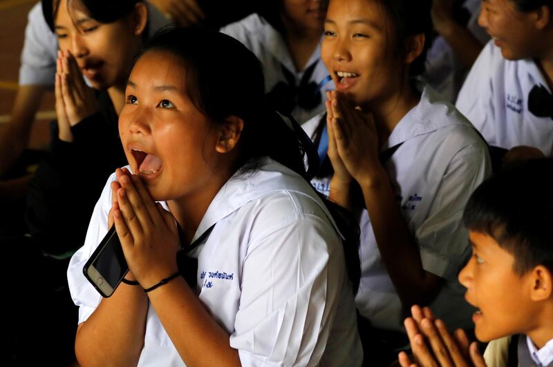 Classmates react after a teacher announced that four of the trapped boys had been rescued. Reuters
