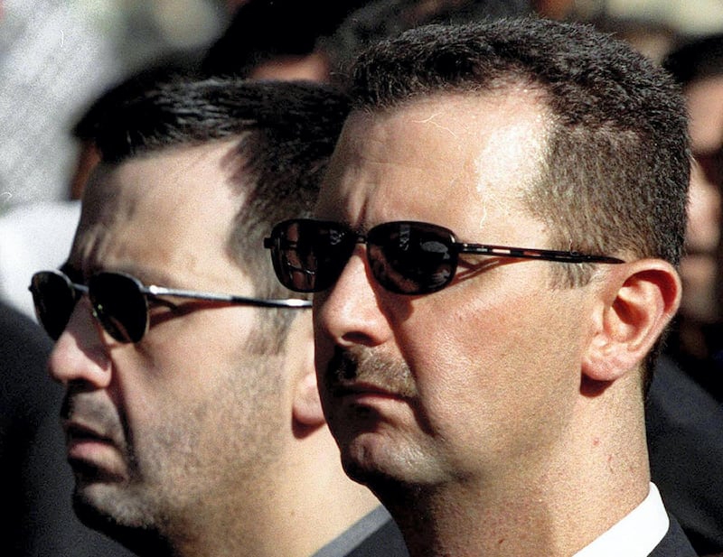 TO GO WITH STORY BY NATACHA YAZBECK
(FILES) A picture dated June 13, 2003 shows Syrian President Bashar al-Assad and his brother Maher (L) attending their father's funeral in Damascus on June 13, 2000. As Bashar al-Assad's regime fights to stay in power, one man has emerged as the symbol of the dynasty's brutal military might -- the president's feared younger brother Maher. AFP PHOTO/RAMZI HAIDAR (Photo by RAMZI HAIDAR / AFP)