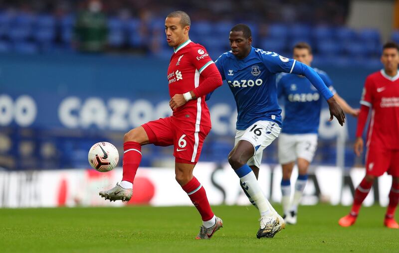 epa08754001 Thiago Alcantara (L) of Liverpool in action against Abdoulaye Doucoure of Everton during the English Premier League match between Everton and Liverpool in Liverpool, Britain, 17 October 2020.  EPA/Cath Ivill / POOL EDITORIAL USE ONLY. No use with unauthorized audio, video, data, fixture lists, club/league logos or 'live' services. Online in-match use limited to 120 images, no video emulation. No use in betting, games or single club/league/player publications.