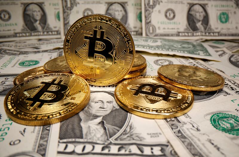 FILE PHOTO: Representations of virtual currency Bitcoin are placed on U.S. Dollar banknotes in this illustration taken May 26, 2020. REUTERS/Dado Ruvic/Illustration/File Photo
