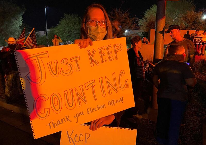 A protester supporting U.S. President Donald Trump holds up a sign outside the Clark County Elections Department. Reuters