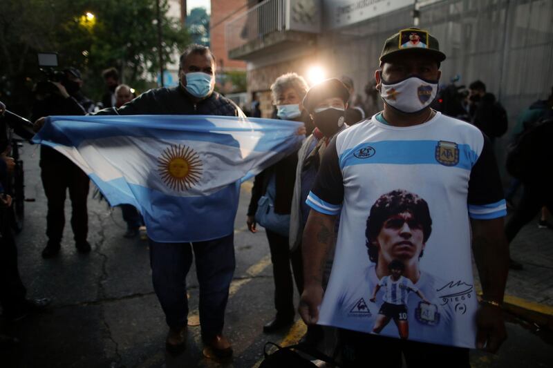 Fans gather outside Clinica Olivos where Diego Maradona underwent surgery in Buenos Aires. AP Photo