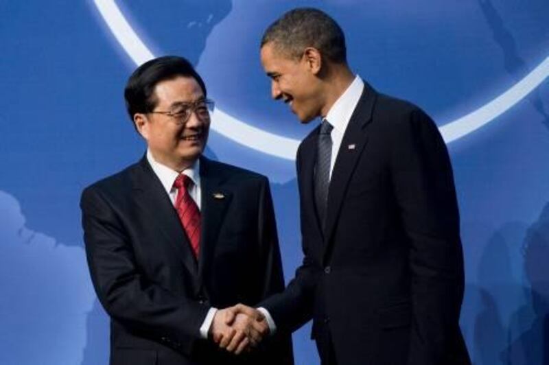 US President Barack Obama (R) greets Chinese President Hu Jintao upon his arrival for dinner during the Nuclear Security Summit at the Washington Convention Center in Washington, DC, April 12, 2010.                    AFP  PHOTO/Jim WATSON