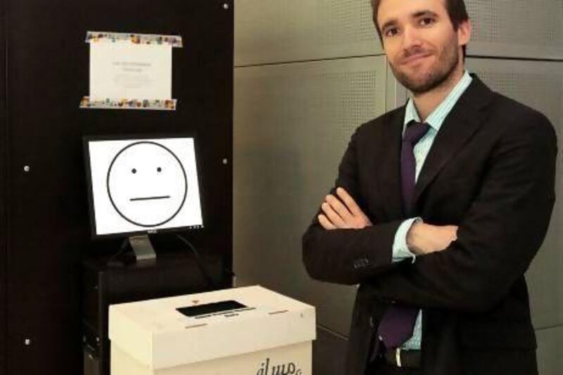 Dr Jose Berengueres with the recycling bin which he and his team developed at the UAE University. Jeffrey E Biteng / The National