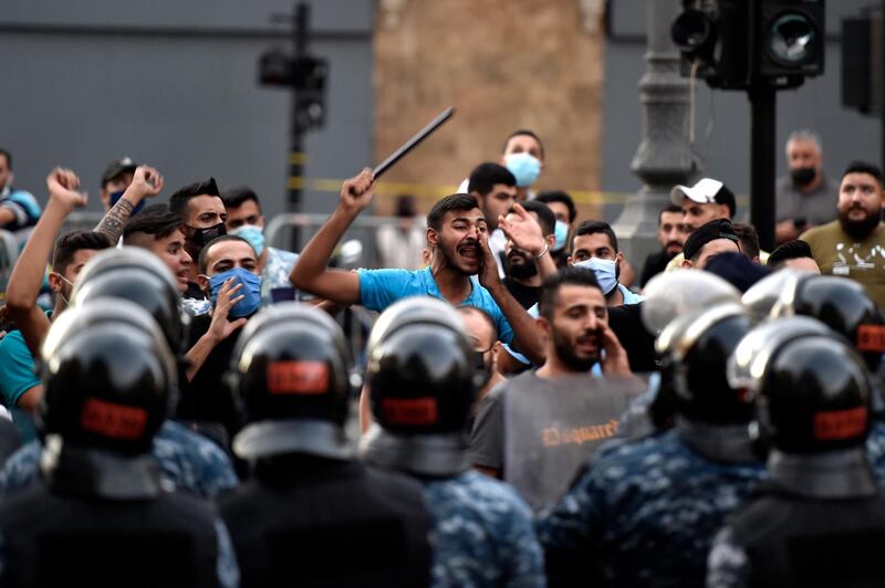 Supporters of former Lebanese Prime Minister Saad Hariri shout slogans against anti-government protesters during a protest against former Prime Minister Saad Hariri in downtown Beirut. EPA
