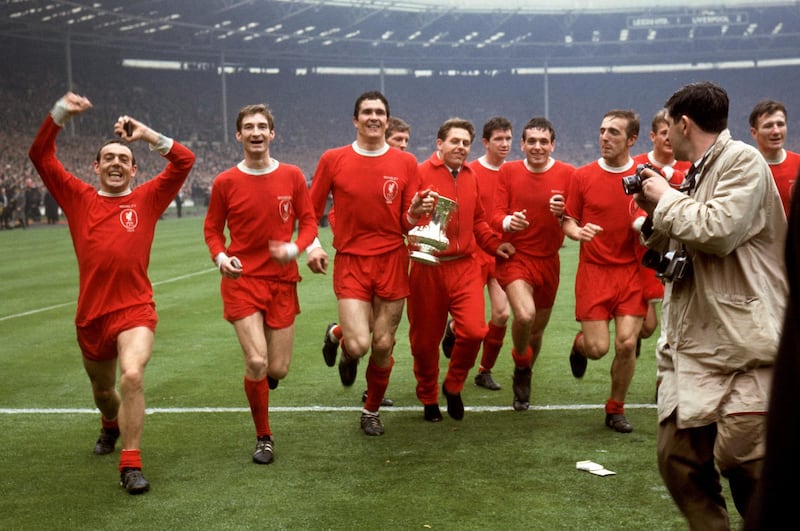 Liverpool's Ian St John, left, celebrates with teammates after beating Leeds. PA