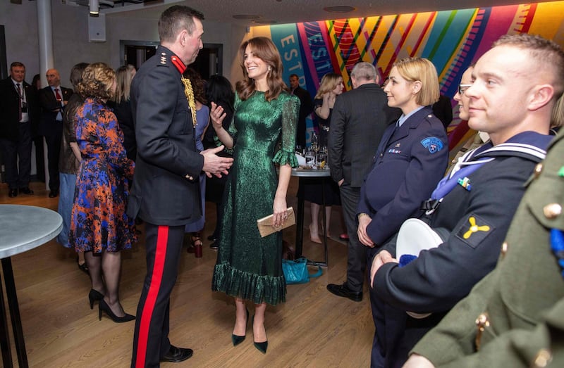 The duchess accessorised with Manolo Blahnik heels, a gold clutch and H&M earrings. AFP