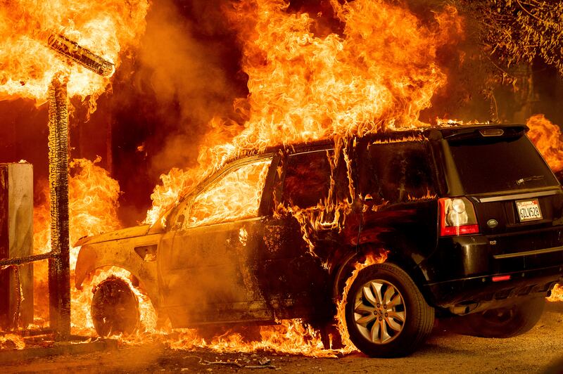 Flames consume a vehicle in Doyle, California.