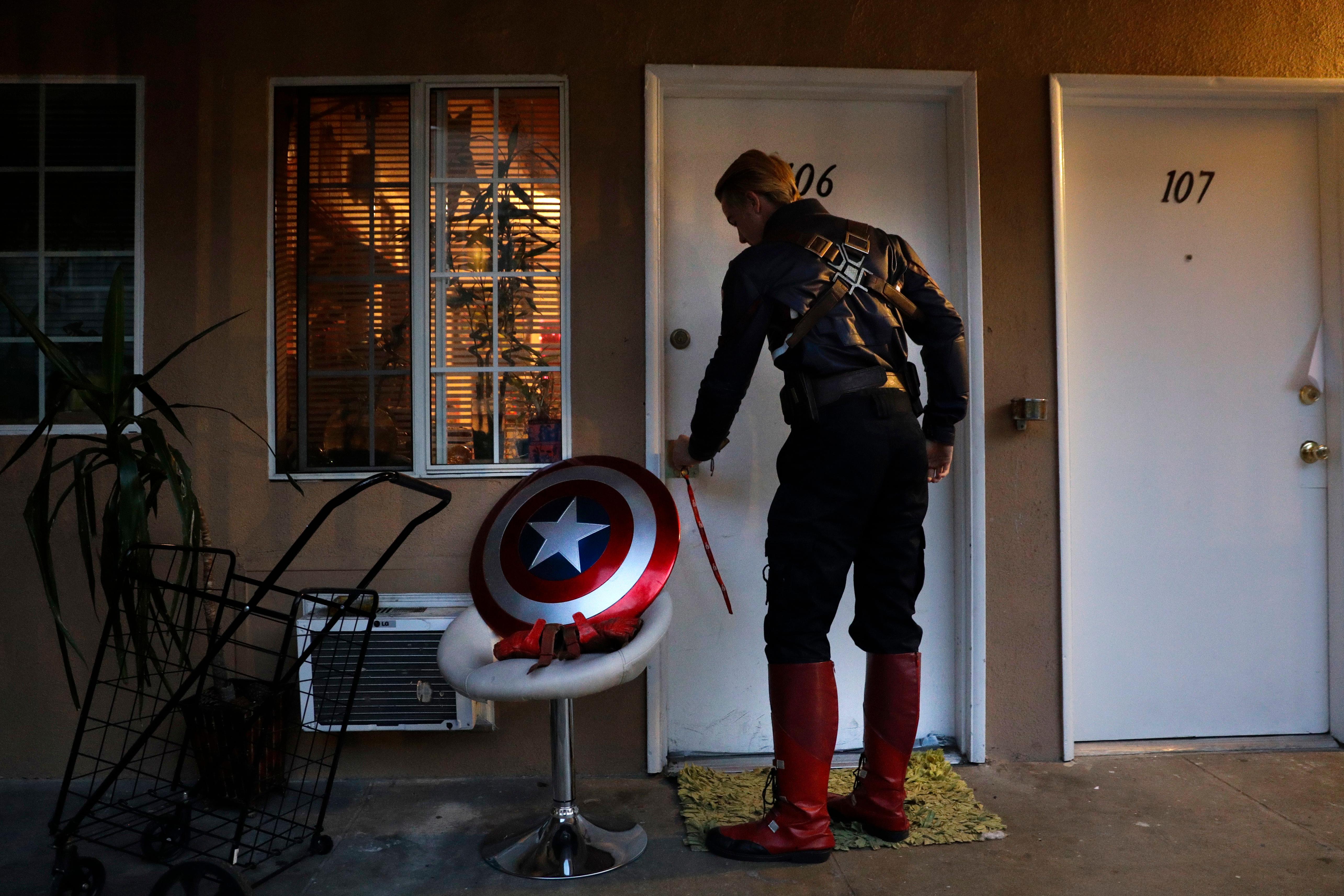 Captain America impersonator Henry Hodge, a cinematographer from England who lives a stone's throw away from Hollywood's Dolby Theatre, opens his apartment door in Los Angeles. "The boulevard is the only thing that gives me the freedom to do what I really want to do," said Hodge. "I never have to miss a film meeting. I'm always available to shoot." Jae C Hong / AP Photo