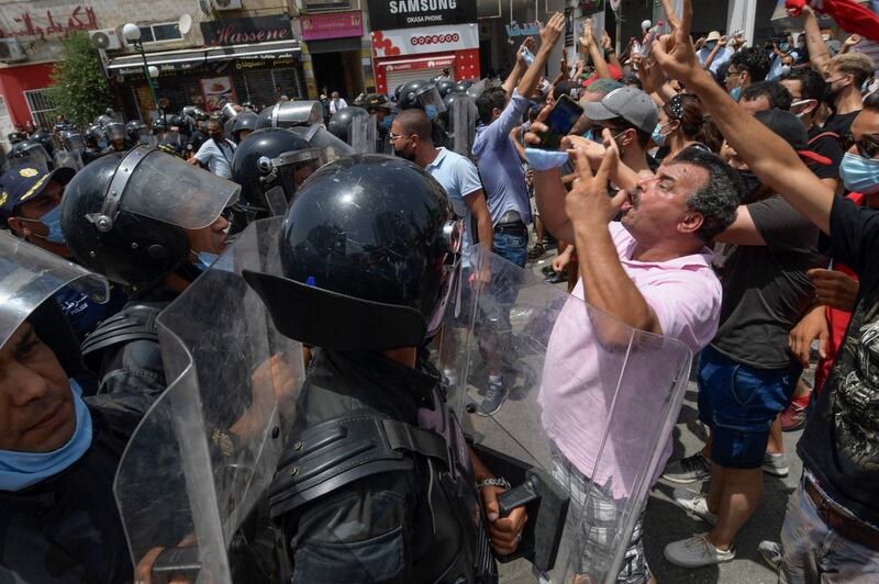 Members of Tunisian security forces face off with anti-government demonstrators.
