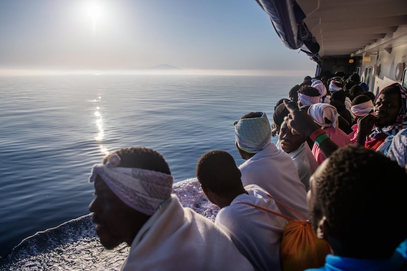 Migrants look out from the 'Aquarius' vessel as they arrive in Trapani, western Sicily, Italy. Some 540 migrants were rescued by members of the NGO 'SOS Mediterranee' during 3 rescues operations off the Libyan coast in the Mediterranean Sea.  Christophe Petit Tesson / EPA