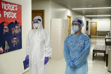 Two nurses stand by an isolation room at Dubai American Academy. The school is gearing up to welcome back pupils next month with a raft of precautions and safety measures. Pawan Singh / The National